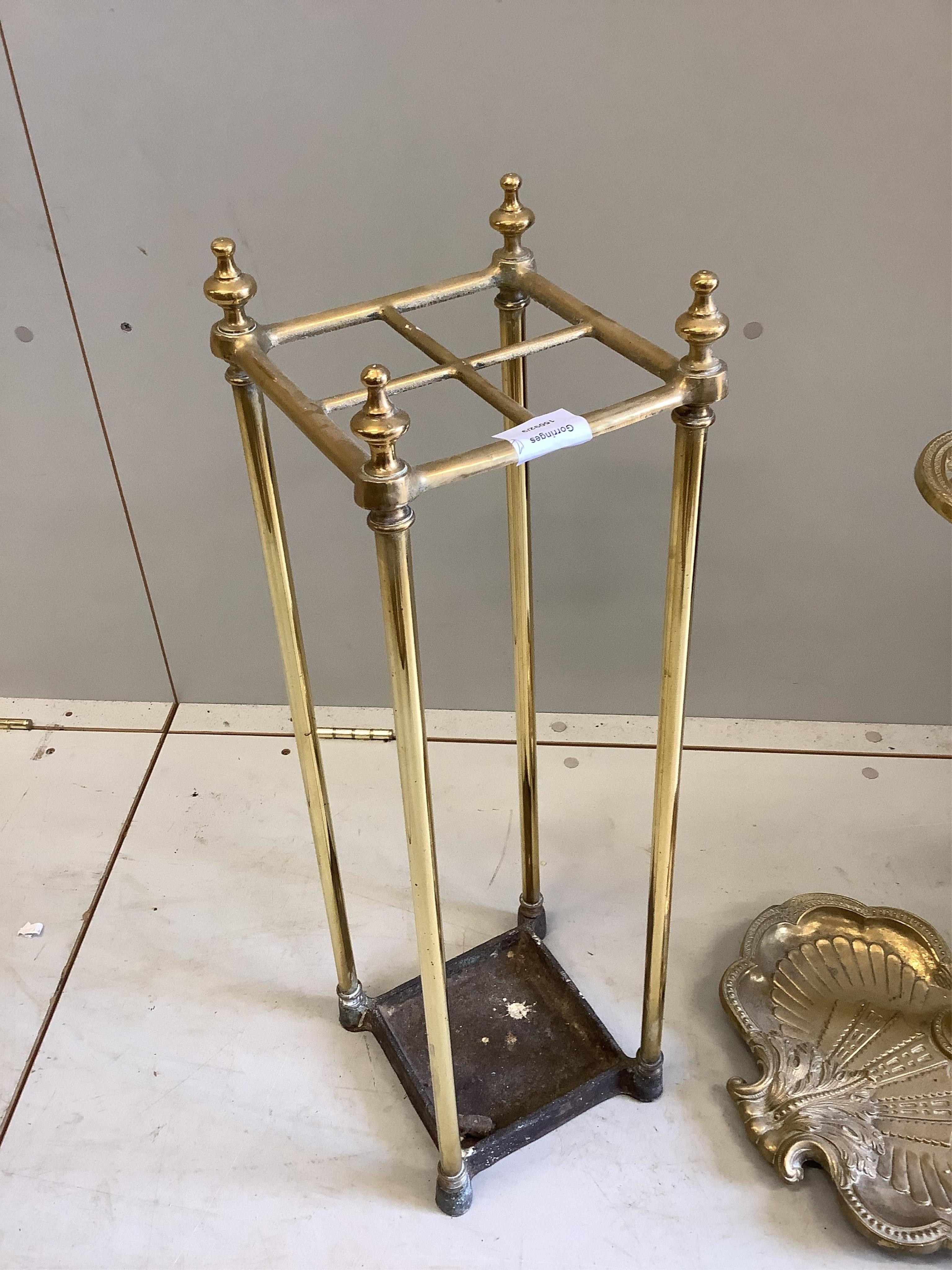 An early 20th century brass and cast iron four division stick stand, height 68cm, together with a reproduction brass stick stand. Condition - good